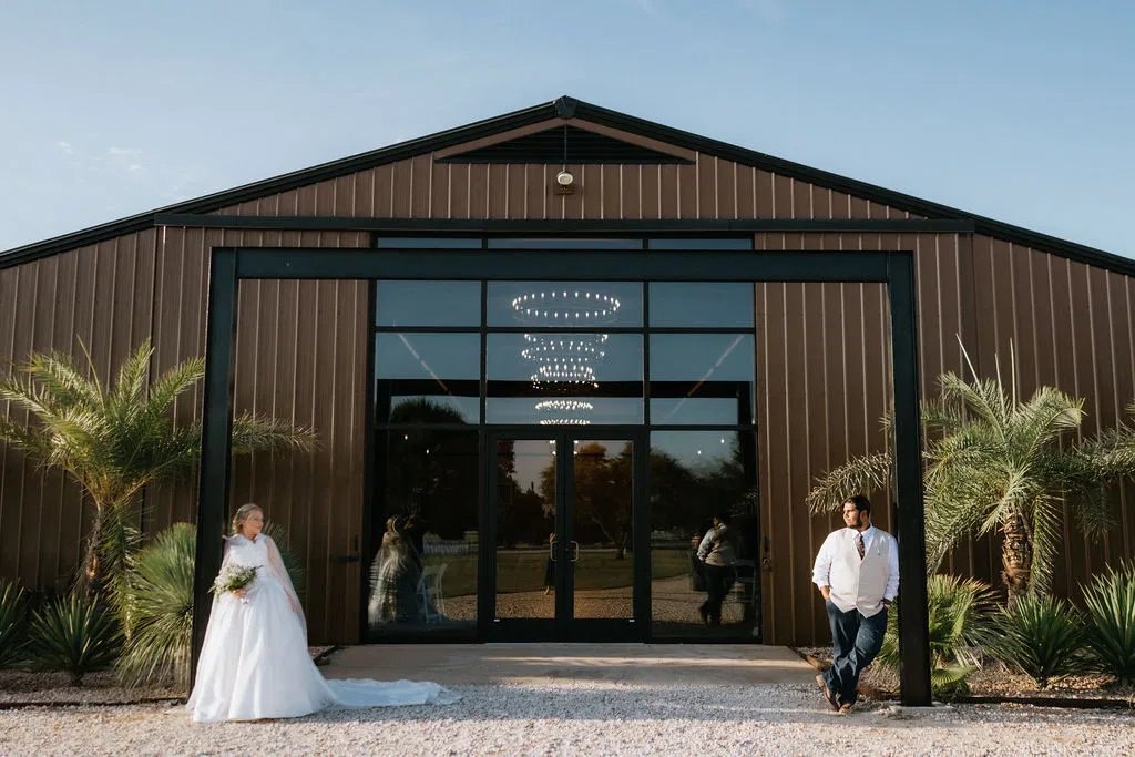 Bride and groom outside the wedding barn at Restoration Ranch