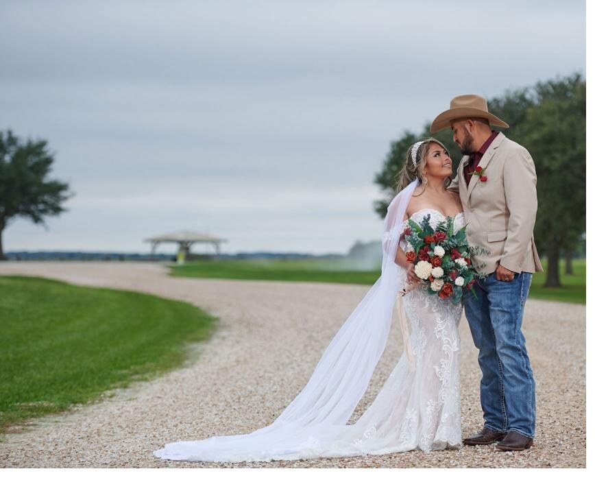 Bride and groom by the lake at the ranch